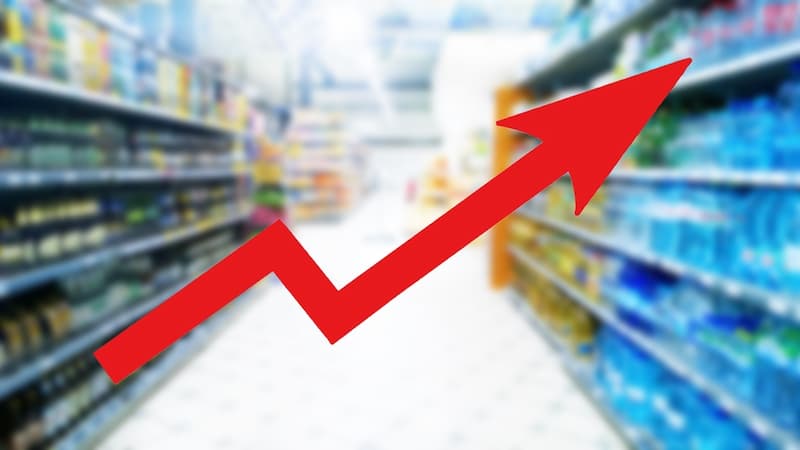 Ein roter Pfeil mit einem Supermarkt im Hintergrund, was bedeuten die aktuellen Zahlen der Inflation?