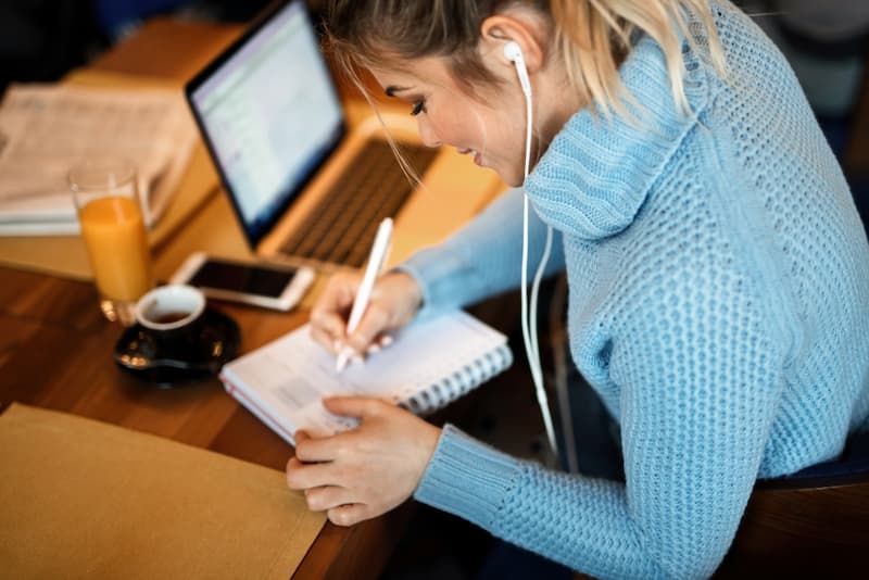 Eine Frau schreibt einen Plan, was ist strukturiertes Arbeiten?